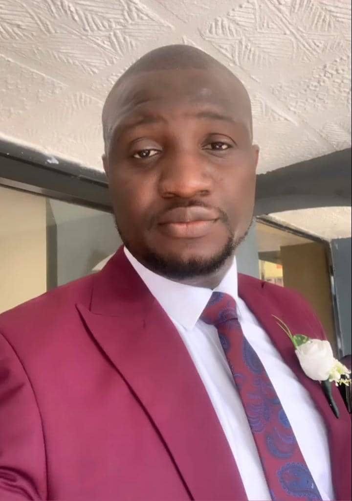 Abayomi in a burgundy suit portrait
