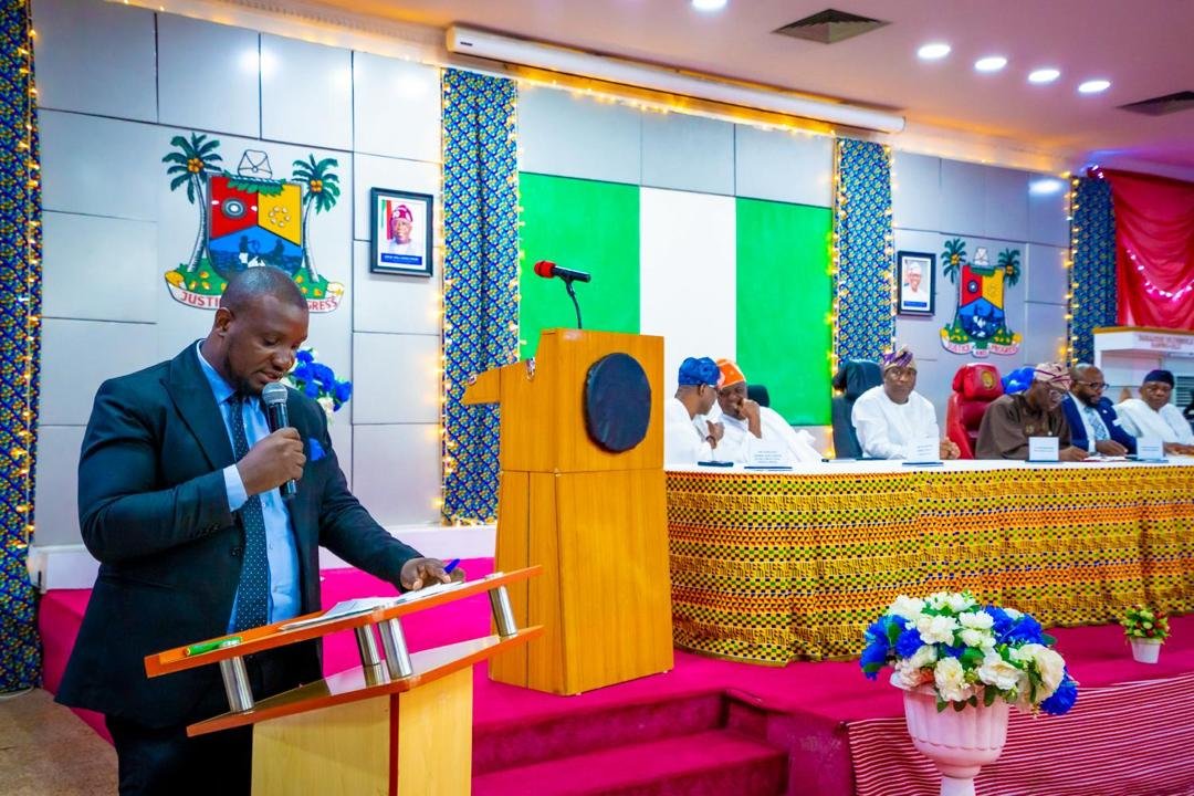 Abayomi speaking in a government hall
