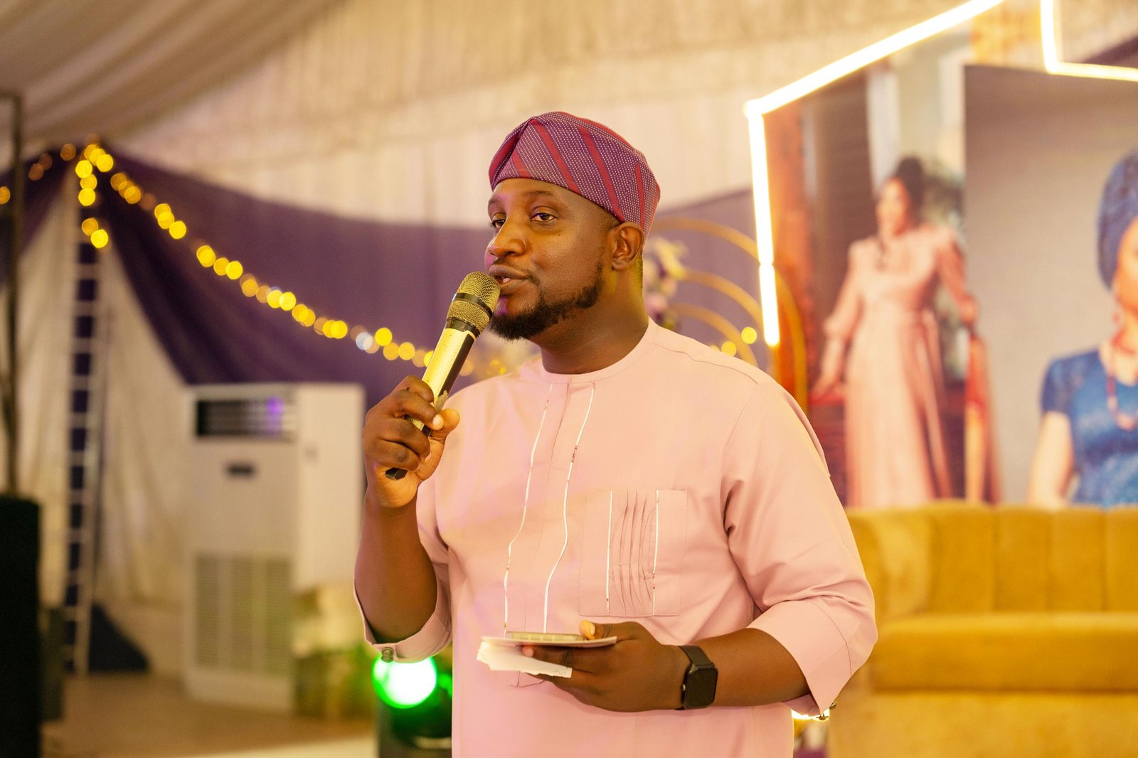 Abayomi speaking in pink traditional attire