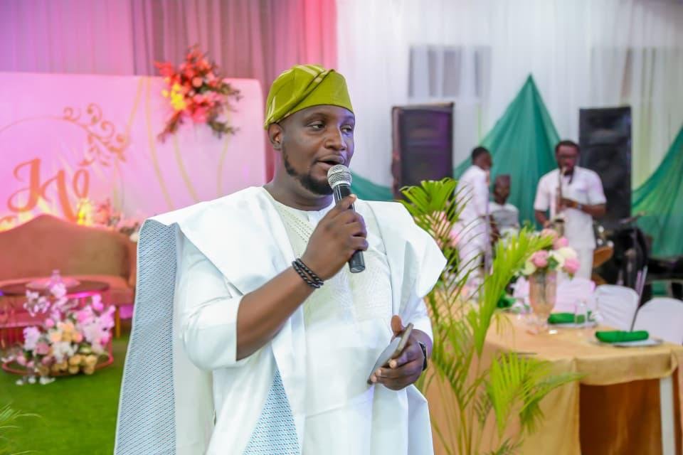 Abayomi hosting in white traditional attire